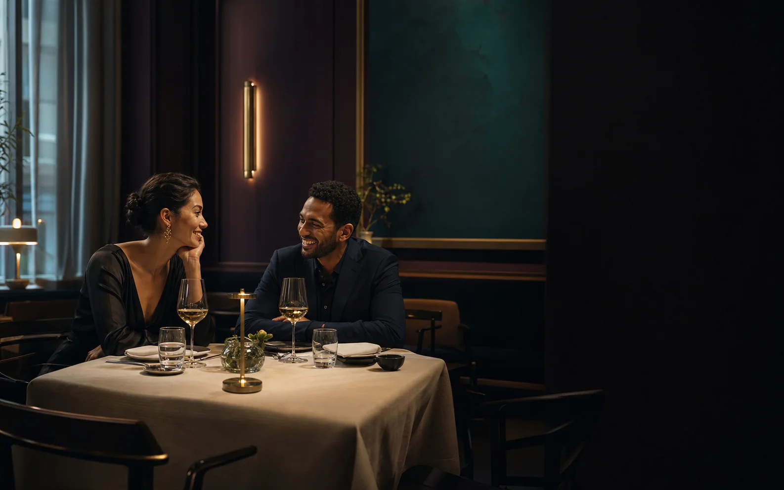A couple sharing a genuine laugh over dinner